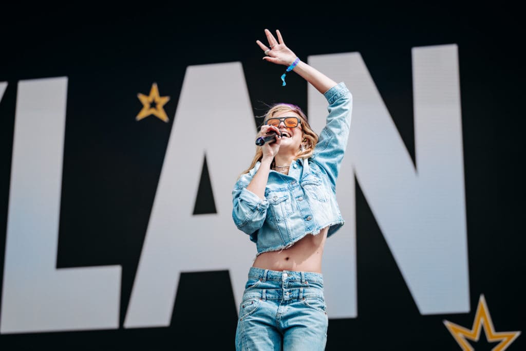Dylan, in a double denim outfit, delivers a high-energy performance at Boardmasters Festival