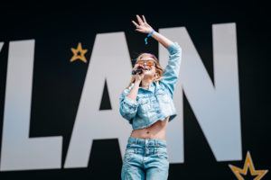 Dylan, in a double denim outfit, delivers a high-energy performance at Boardmasters Festival